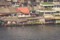 Wooden slums on stilts on the riverside of Chao Praya River in B Royalty Free Stock Photo