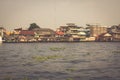 Wooden slums on stilts on the riverside of Chao Praya River in Bangkok, Thailand Royalty Free Stock Photo