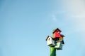 Wooden small bird houses and birdhouses against the blue sky.