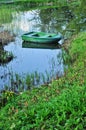 Green boat on the pond in the garden Royalty Free Stock Photo