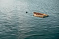 Wooden small boat sinking on a calm lake in Pais Vasco, Spain Royalty Free Stock Photo