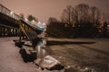 Wooden small bridge on a frozen lake on a frosty winter evening Royalty Free Stock Photo