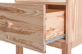 Wooden small cabinet with open drawer on white background, closeup.
