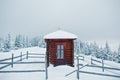 Wooden small church chapel at pine trees covered by snow on mountain Chomiak. Beautiful winter landscapes of Carpathian mountains Royalty Free Stock Photo