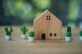 Wooden small house with miniature cactus on wooden table Royalty Free Stock Photo