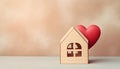 Wooden small house with red heart for happy family. Real estate, sweet home, investment, mortgage and buy new property