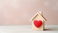 Wooden small house with red heart for happy family. Real estate, sweet home, investment, mortgage and buy new property