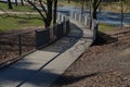 Wooden smooth surface of the ramp for wheelchairs, cyclists and mothers with prams. wooden planks and metal lattice fill the raili