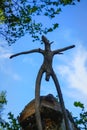 Wooden snag in the form of a pagan idol against the blue sky Royalty Free Stock Photo