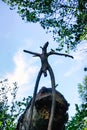 Wooden snag in the form of a pagan idol against the blue sky Royalty Free Stock Photo