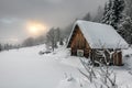Wooden snow covered cabin in mountains Royalty Free Stock Photo