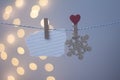 Wooden snowflake on a clothespeg on a blue background