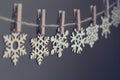 Wooden snowflakes on clothespegs on a rope