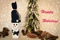 Wooden snowman and pine cones with Happy Holidays text Royalty Free Stock Photo