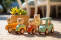 Wooden soft color blue red toy vans with brown wheals. Mini yellow flowers in a pot. A summery background. Copy space.