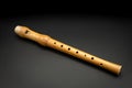 A wooden soprano recorder lying on black background