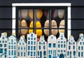 Dutch clogs behind a window and souvenir Amsterdam houses Royalty Free Stock Photo