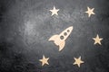 Wooden space rocket and stars on a dark background. The concept of space travels, the study of planets and stars. Education