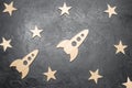 Wooden space rocket and stars on a dark background. The concept of space travels, the study of planets and stars. Education