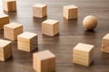 Wooden sphere ball among the wood cubes. different in niche market concept Royalty Free Stock Photo