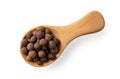 Wooden spice shovel full of allspice pimento berries cutout. Jamaica pepper grains in a wooden spoon isolated on a white Royalty Free Stock Photo