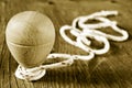 Wooden spinning top with a string coiled in its axis, in sepia t Royalty Free Stock Photo