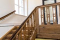 Wooden, spiral staircase in an old building in dark brown color. Royalty Free Stock Photo