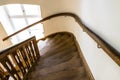 Wooden, spiral staircase in an old building in dark brown color. Royalty Free Stock Photo