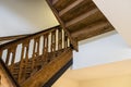 Wooden, spiral staircase in an old building in dark brown color. Royalty Free Stock Photo