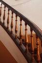 Wooden spiral staircase railing with selective focus. Old house interior vertical shot