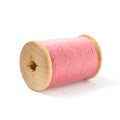 The wooden spool with pink thread