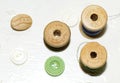 Wooden spools of thread and ceramic and plastic buttons Royalty Free Stock Photo