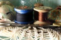 WOODEN SPOOLS WITH THREAD AND NEEDLE WORK EQUIPMENT Royalty Free Stock Photo