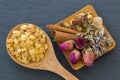 Wooden spoon of aromatic yellow resin gum next to dried flowers Royalty Free Stock Photo
