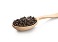 Wooden spoon with black pepper grains Royalty Free Stock Photo