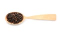 Wooden spoon with black pepper grains on white background Royalty Free Stock Photo