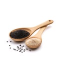 A wooden spoon with black seeds and a spoon with a few grains in it with white background Royalty Free Stock Photo