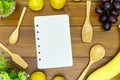 Wooden spoon and Blank recipe book on wooden table Royalty Free Stock Photo