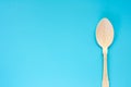 Wooden spoon on blue background