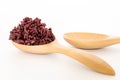 Wooden spoon with brown rice ready to eat. Deep Purple rice, Homnil rice. Royalty Free Stock Photo