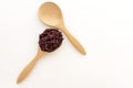 Wooden spoon with brown rice ready to eat. Deep Purple rice, Homnil rice. Royalty Free Stock Photo