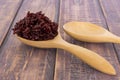 Wooden spoon with brown rice ready to eat. Deep Purple rice, Royalty Free Stock Photo