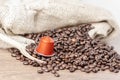 Wooden spoon and capsule coffee on cofeee beans Royalty Free Stock Photo