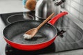 Wooden spoon with coconut oil in frying pan. Royalty Free Stock Photo