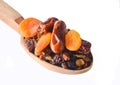 Wooden spoon with dates, dried apricots, raisins isolated on white background. Dried fruits. Royalty Free Stock Photo