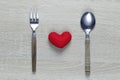 Wooden spoon and dish and red heart on wooden floor with copy space Royalty Free Stock Photo