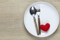 Wooden spoon and dish and red heart on wooden floor with copy space Royalty Free Stock Photo