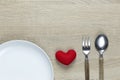 Wooden spoon and dish and red heart on wooden floor with copy space Royalty Free Stock Photo