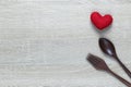 Wooden spoon and dish and red heart on wooden floor with copy space Royalty Free Stock Photo