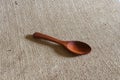 Wooden spoon on fabric hemp sack background